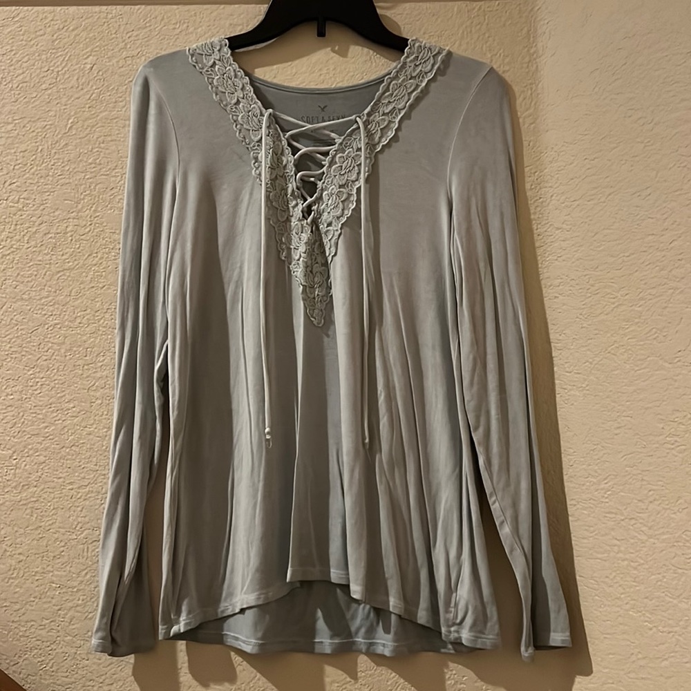 Soft and Sexy American Eagle soft teal blouse with tie up lace neck line.